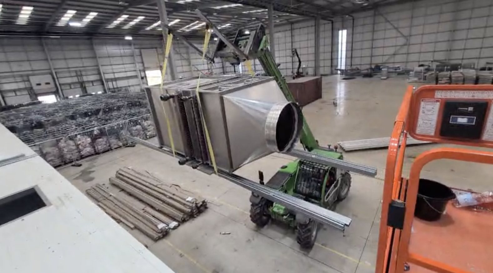 Industrial chiller unit being lifted by a telehandler during the Fairman Knight & Sons chiller relocation project